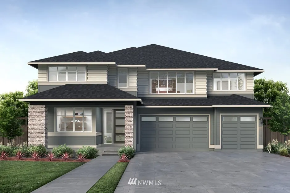 Two-story grey house with brick accents and a three-car garage.